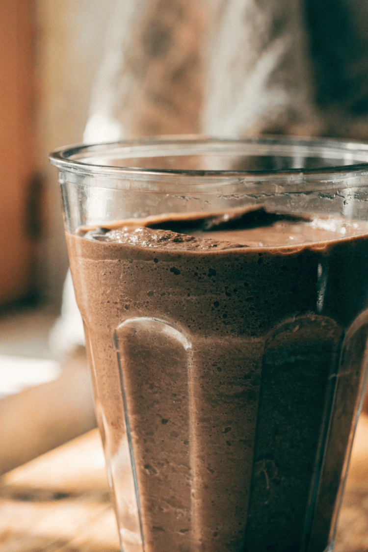 blended banana chocolate mixture in a glass blender