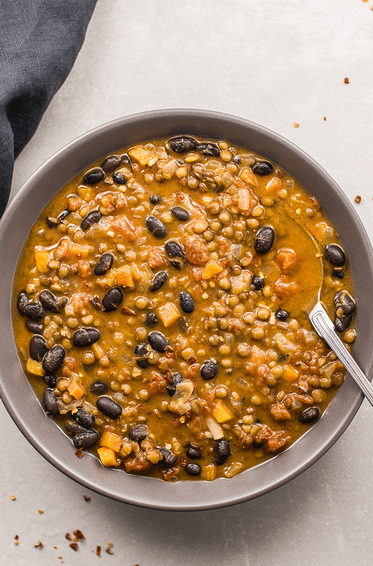 black bean and lentil soup in a bowl with a spoon