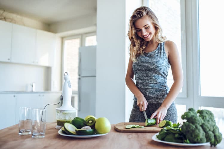 Woman preparing a meal from scratch.