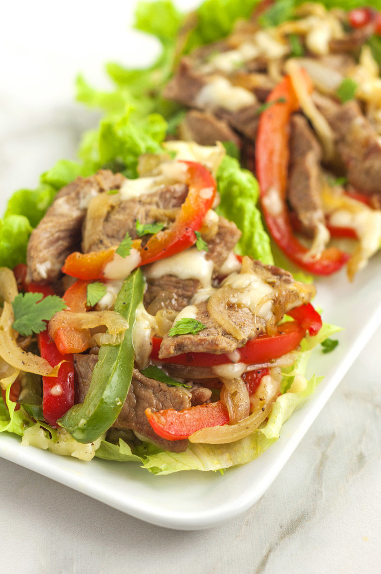 bright green lettuce filled with grilled peppers, onions, and steak slices and topped with provolone cheese.