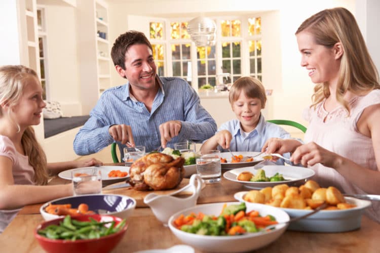 A family enjoying dinner together at the table.