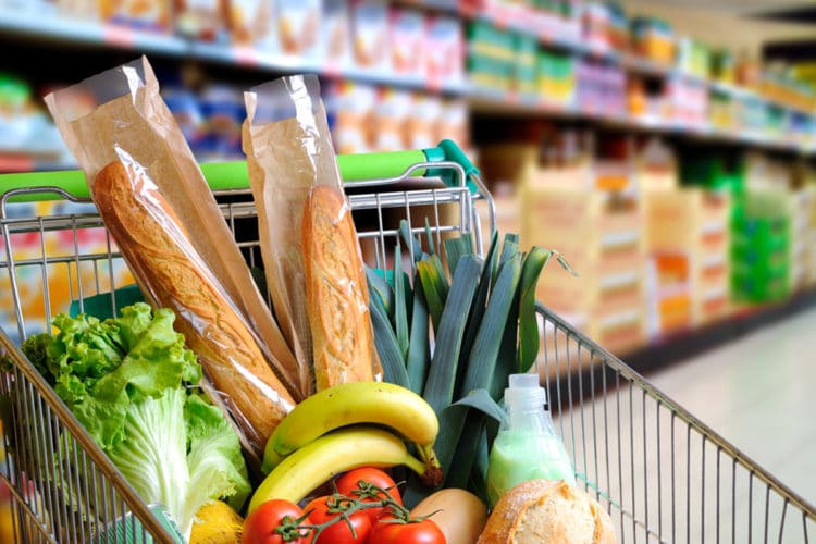A grocery cart full of healthy foods that will help clear brain fog.
