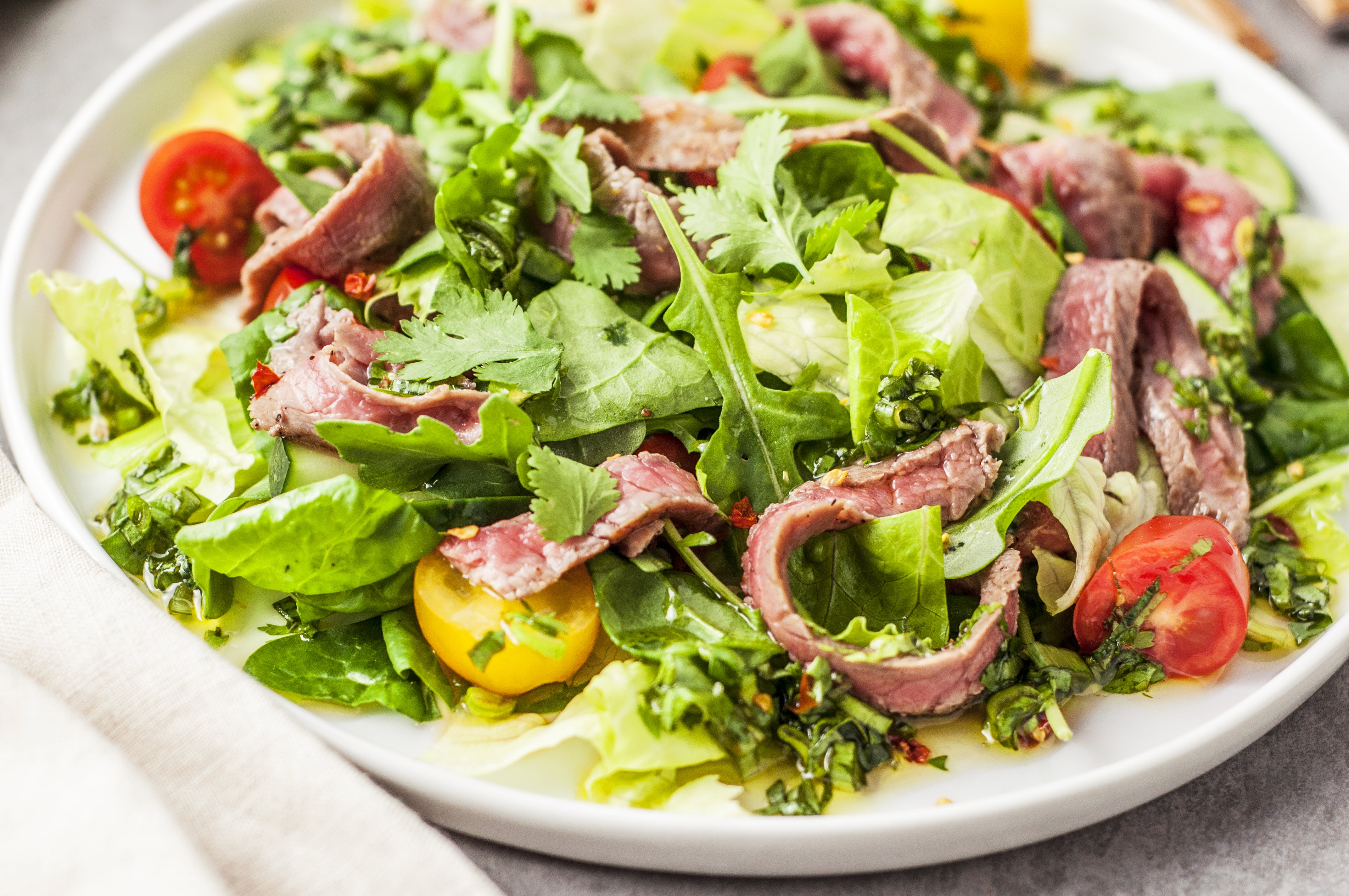 thai beef salad recipe on a white place with a close up view