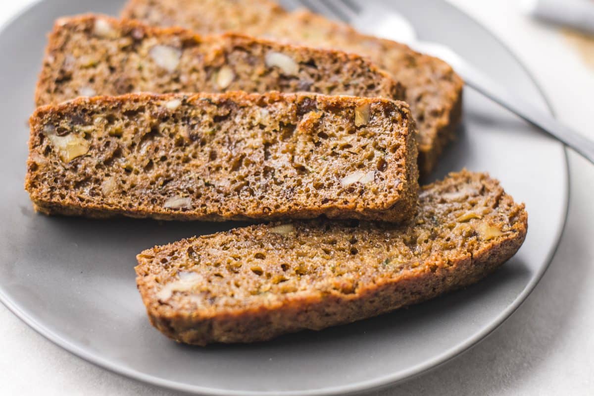 sliced zucchini bread on a gray plate