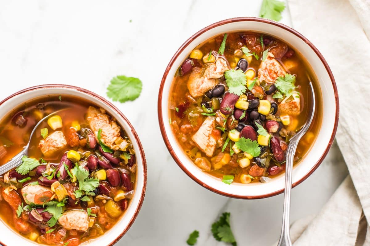 two bowls of soup with spoons