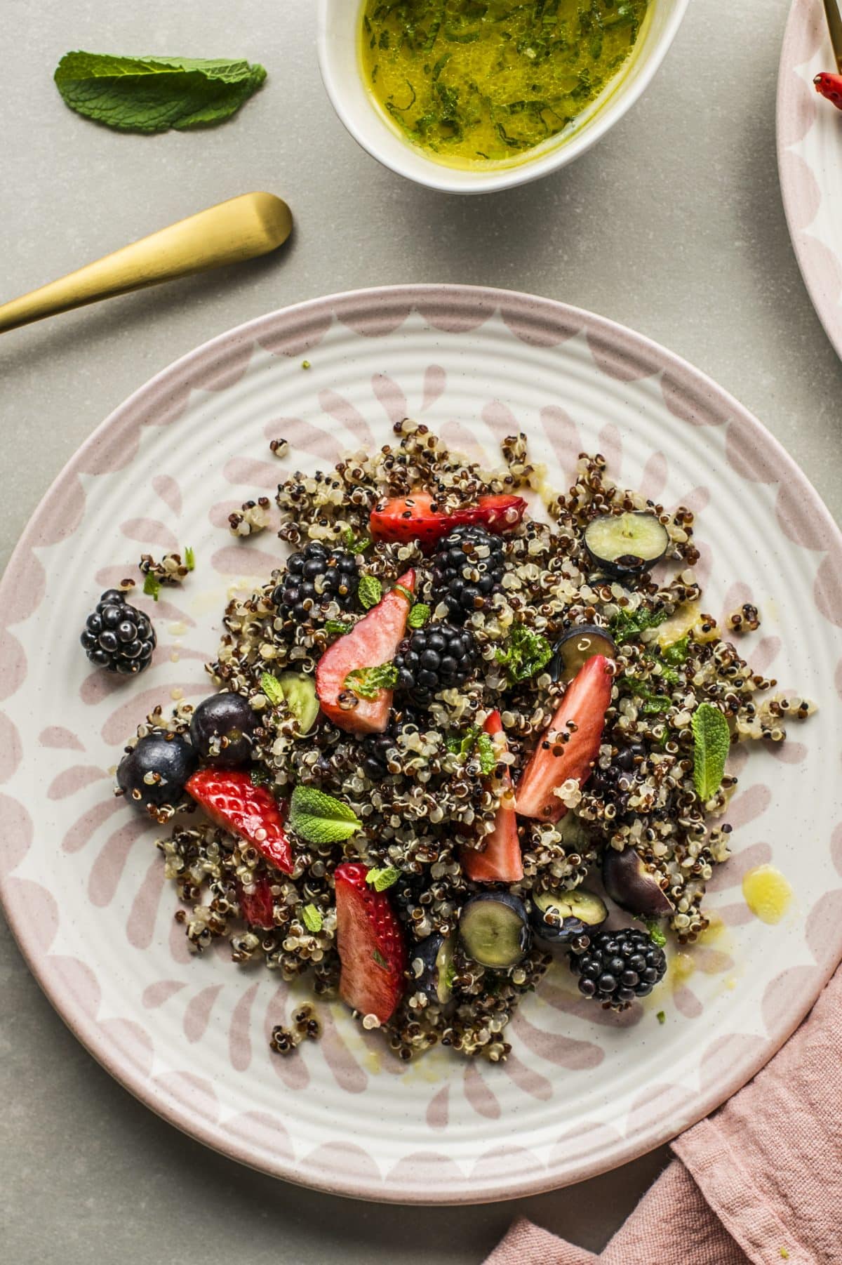 mixed berry quinoa salad on a white plate