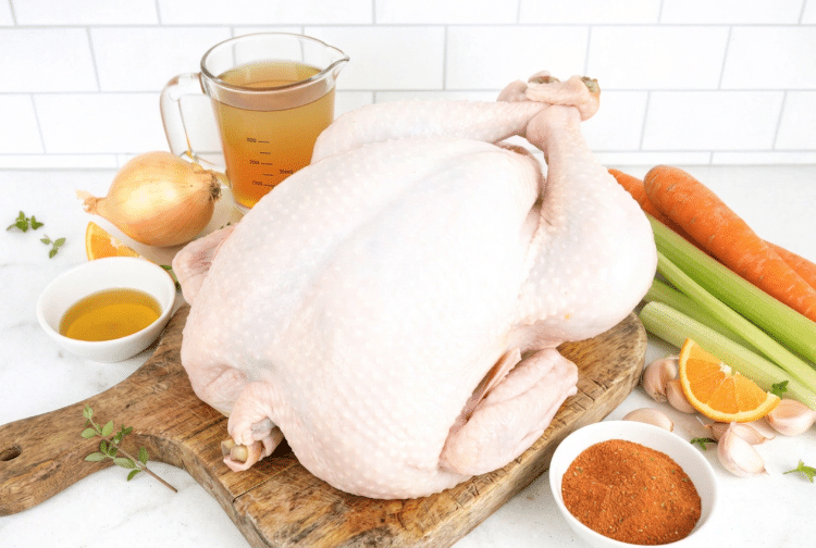 The thawed turkey surrounded by the other ingredients for how to cook a turkey and gravy