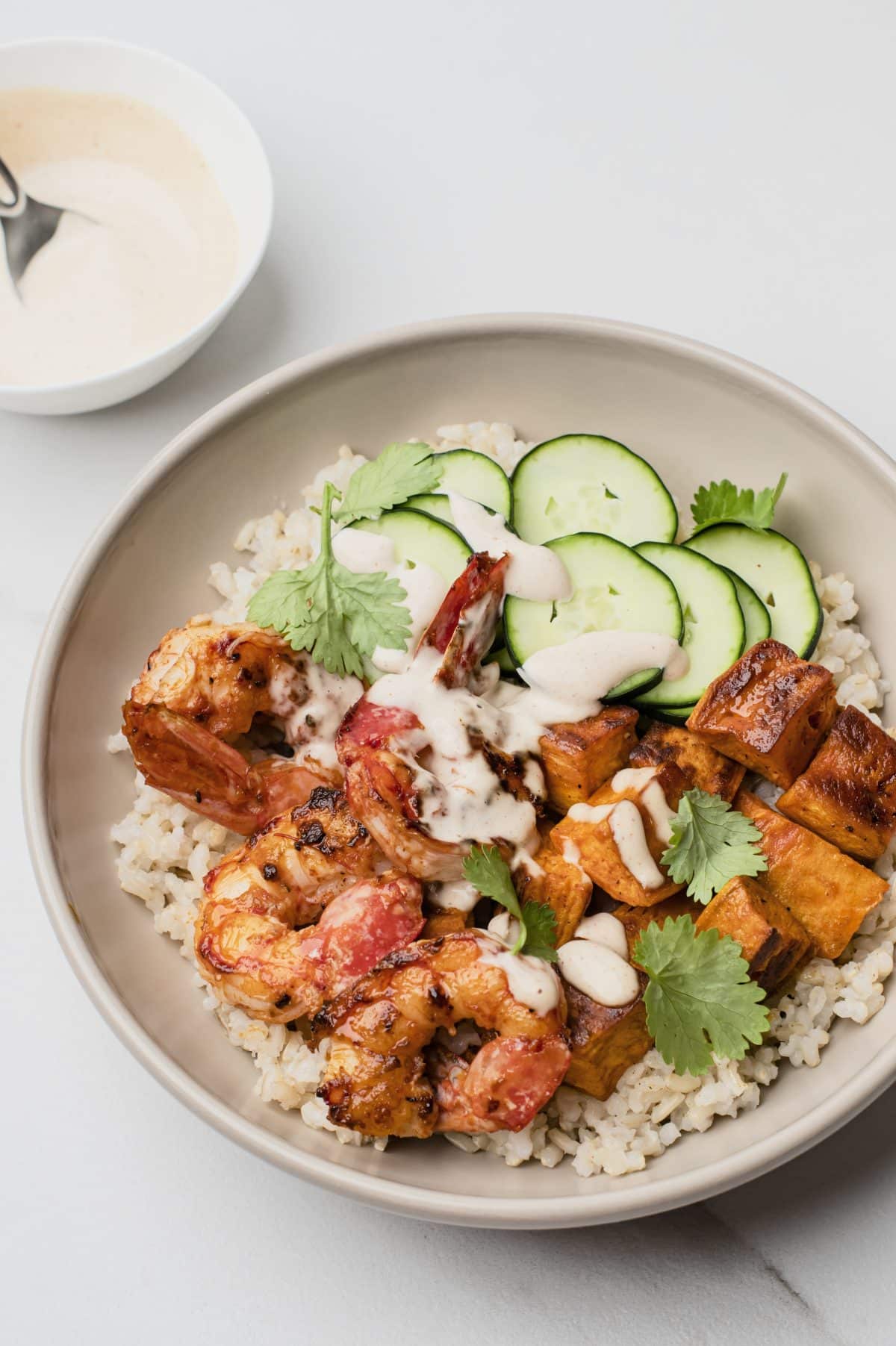 Another close up image of a build your own grain bowl with a partial view of sauce in upper left corner