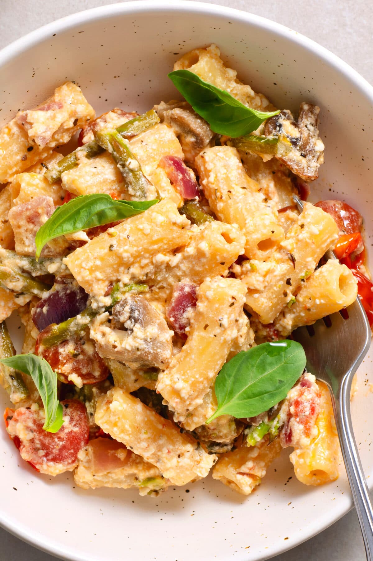 Tender pasta, baked feta, tomatoes, mushrooms, and more make for one delicious meal!