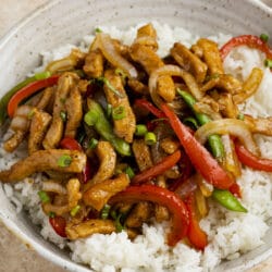 This Garlic Ginger Pork Stir Fry is super delicvious, especially when it's served over a bed of healthy fried rice!