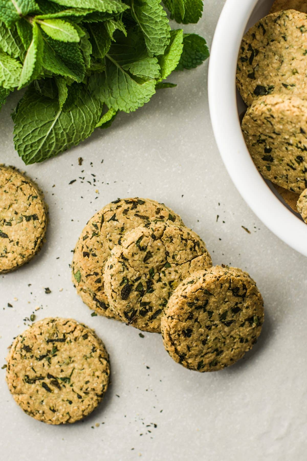 Mint dog cookie treats on a table and in a bowl
