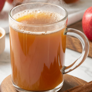 close up of apple cider in a see-through mug