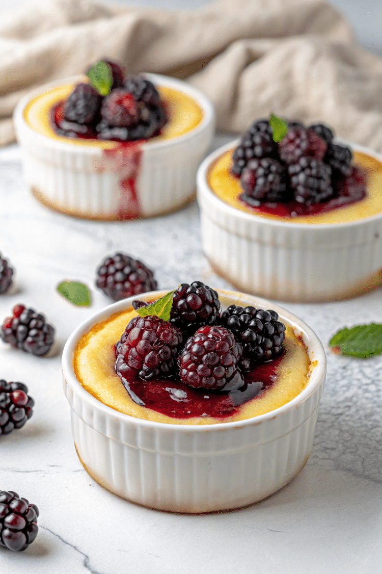 fresh blackberries on top of cheesecake in ramekin