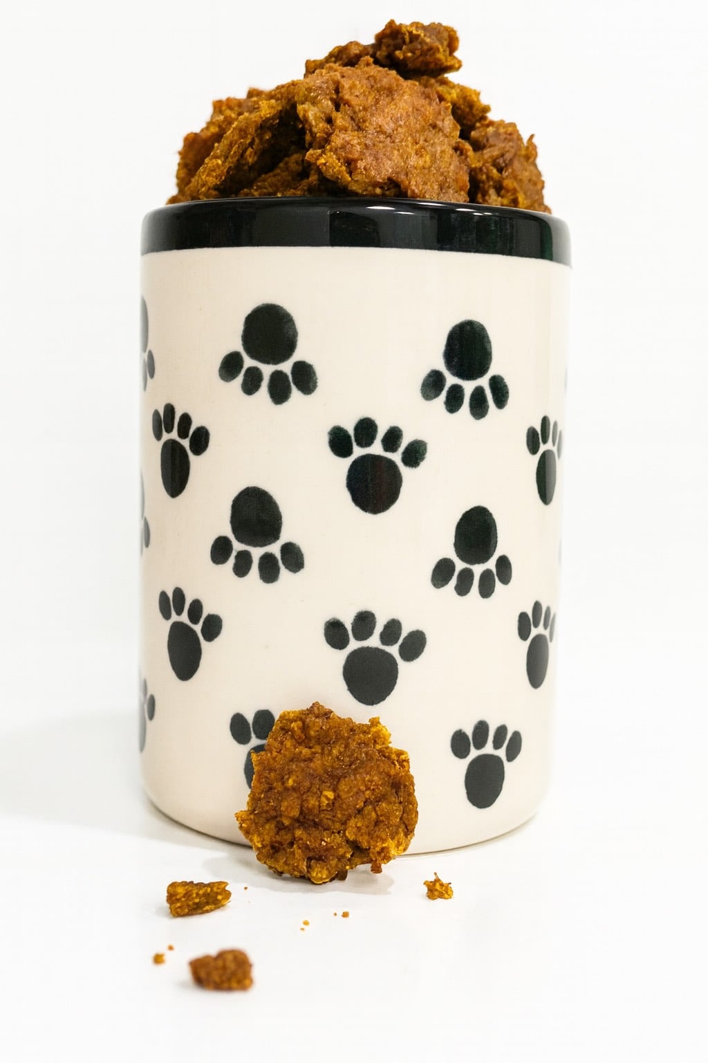 Dog cookies in a treat jar with paw prints