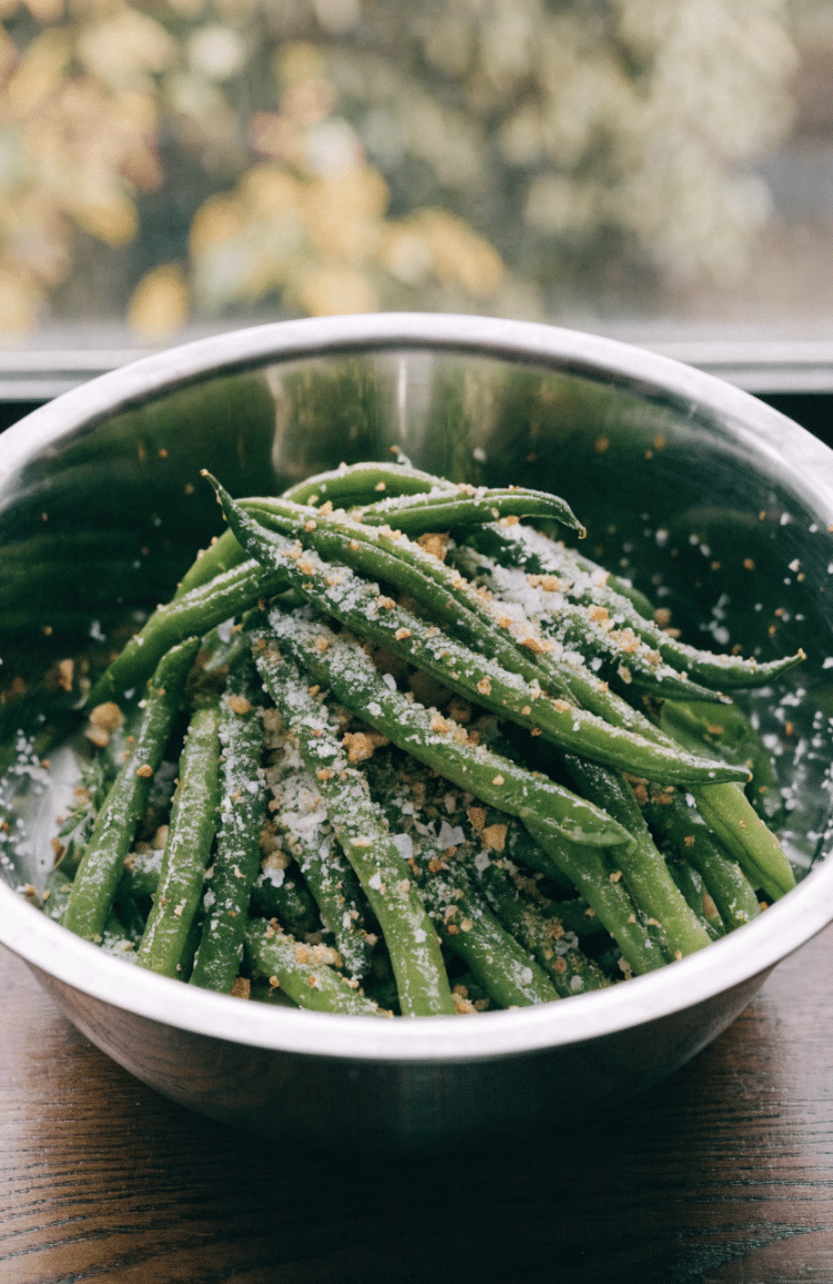 Green beans and other ingredients in a mixing bowl